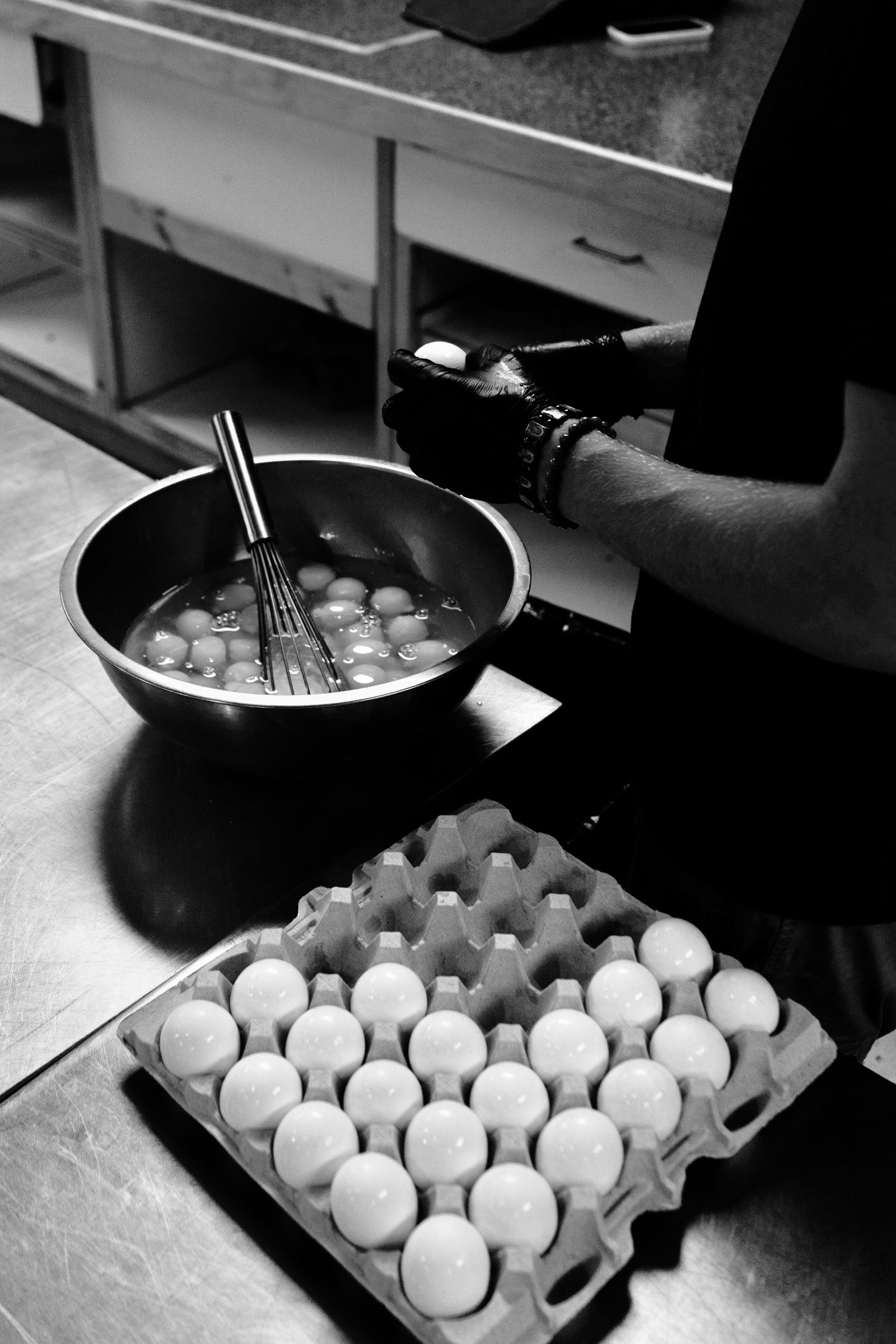 Cracking eggs into a mixing bowl