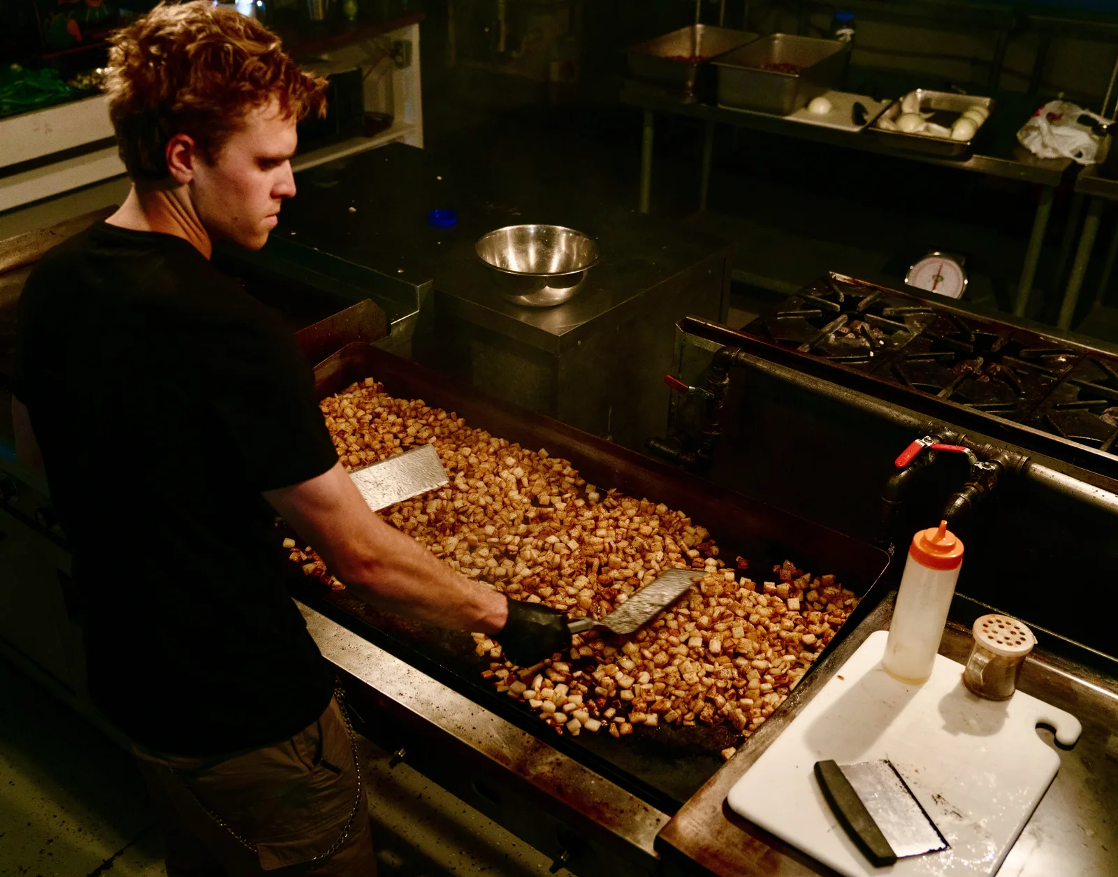 Carson cooking potatoes on the griddle