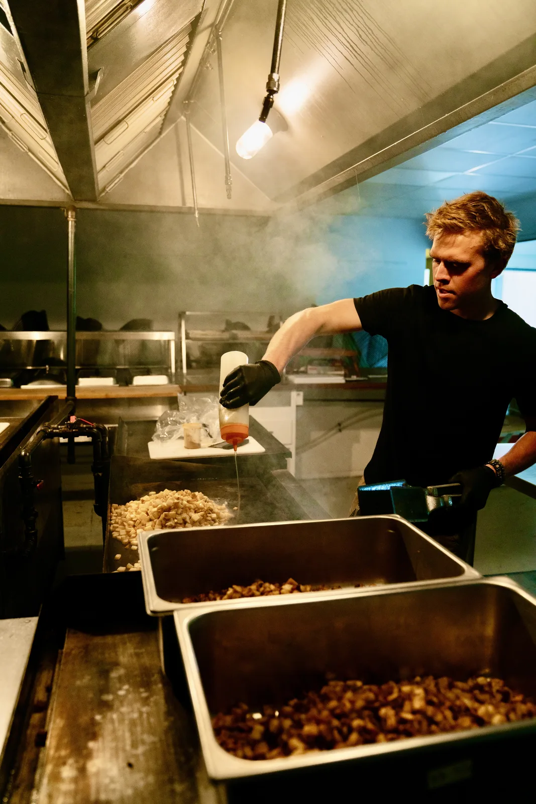 Carson cooking a big batch of breakfast burritos in the kitchen